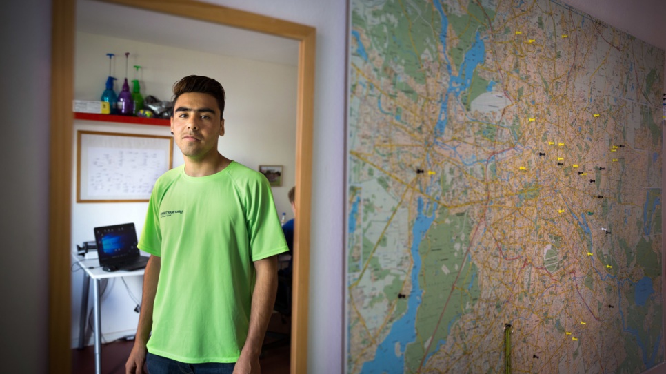 Hassan stands in the office at Ankommen.