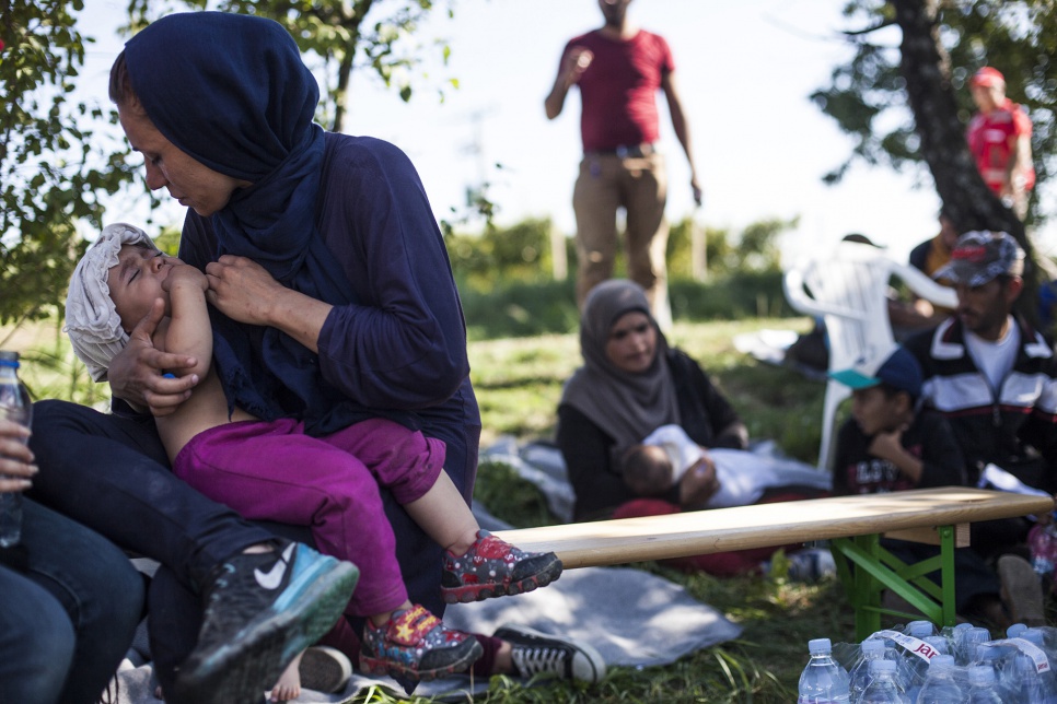 Mothers tend to their children near the border crossing at Bapska, Croatia.