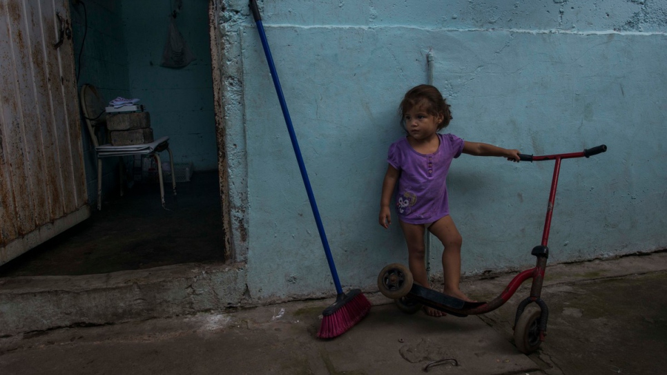 Brenda's granddaughter plays ouside the room rented by her family in Tapachula.