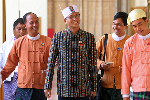 Henry Van Thio (C), an ethnic Chin lawmaker in Myanmar's upper house of parliament, walks with other deputies through the National Assembly building in Naypyidaw, March 10, 2016.
