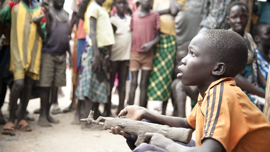 Ethiopia / South Sudanese Refugees / Gatluak, 11, is one of many boys making kalashnikovs out of mud at Lietchuor refugee camp in Ethiopia. Around 45,000 people have fled their homes in South Sudan to come to this dismal camp built on a floodplain in Ethiopia. The floodwaters have drained, but as the roads dry up, many boys like Gatluak dream of making their toy mud guns real and heading home to fight in an increasingly ethnic civil war that has already reeled in many young boys. "It only takes five minutes to make one of these. Yesterday I made three. It's an AK47. I like making guns because my people and the Dinka [ethnic group] are fighting and one day when I grow up I want to fight them too. I don't like it here, I like my country, but the one before the soldiers came and took it. I want to go back next month, but I'm too small now to be a soldier so I have to wait here for a few years" UNHCR / Catianne T./ November 2014