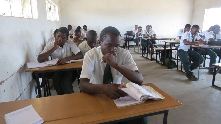 David Mulondo Gustave concentrates during class at Tongogara Secondary School in Zimbabwe. He hopes to one day attend university and become a civil engineer. UNHCR/T. Ghelli