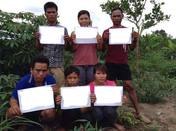 Six Montagnards hold signs showing their names and location in Cambodia, July 16, 2015.
