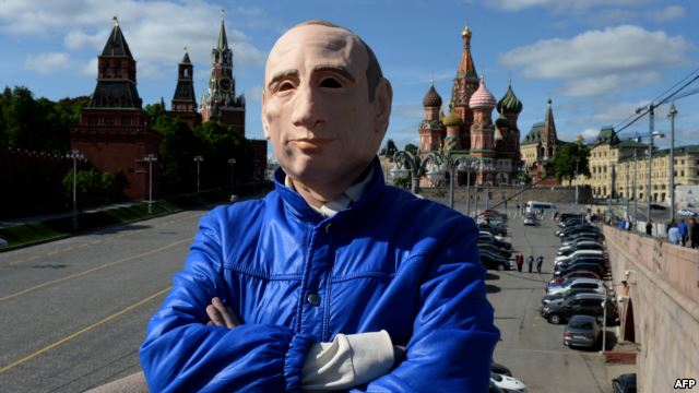 Russian activist Roman Roslovtsev, wearing a rubber mask depicting President Vladimir Putin, poses for a picture in central Moscow on May 12.