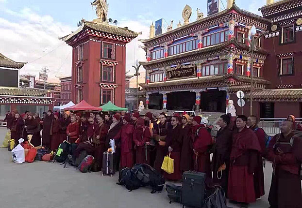 Monks and nuns wait to be taken away from Larung Gar in an undated photo.