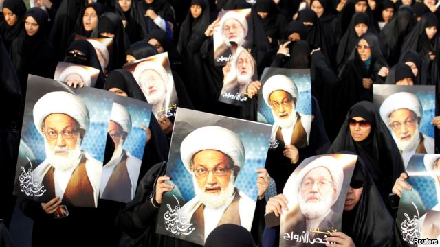 Bahraini protesters hold up posters of Shi'ite cleric Ayatollah Isa Qassem during an antigovernment demonstration in 2013.