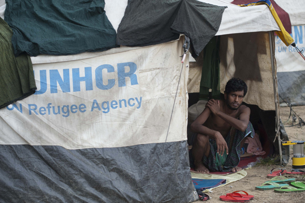 A migrant rests in a temporary refugee camp near the Bangladesh border in western Myanmar's Rakhine state, June 5, 2015.