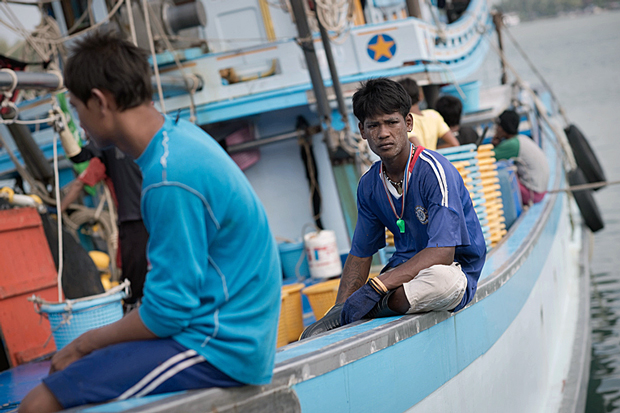 Myanmar nationals and migrant workers work on a fishing boat in waters off Ban Nam Khaem village in southern Thailand's Phang-nga province, Dec. 3, 2014.
