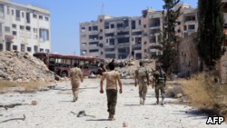 Syrian Army soldiers patrol an area on the outskirts of Aleppo. 