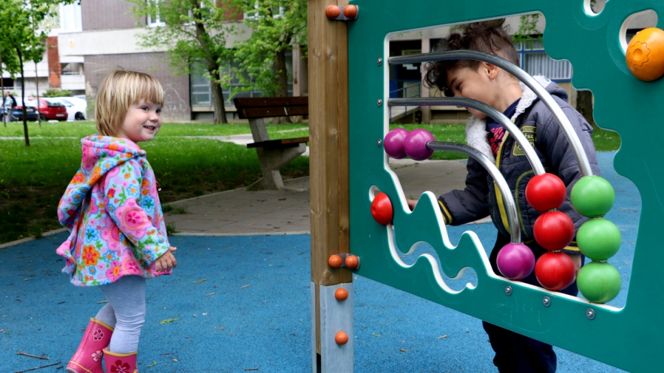 Yousif plays with a friend at the playground.