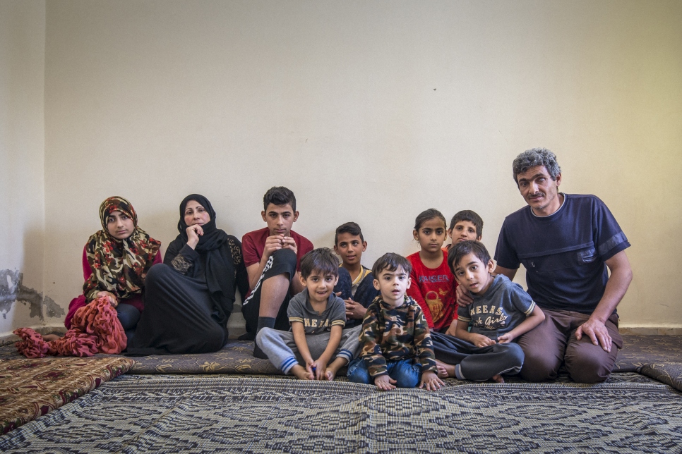 Hasan, a 43-year-old father of eight from Aleppo, cannot work due to a degenerative eye condition. His family relies on the 155 dinars they receive from UNHCR each month to cover the rent on their apartment.