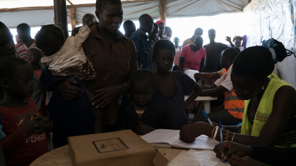 South Sudanese refugee Sidah Hawa being registered with her children at Kuluba transit centre.
