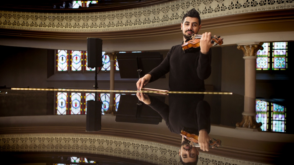 Sari plays his violin in the Alix Goolden Performance Hall.
