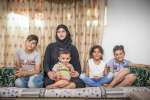 Syrian refugee Fatmeh, 31, with four of her eight children in Amman, J...