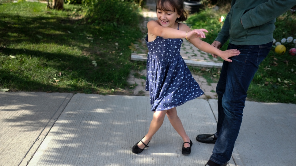 Bayan plays football with her father at their home in Peterborough.