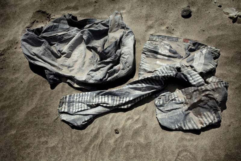 Bottles, clothing and other items left behind by migrants and refugees outside Ahwar reception centre. 