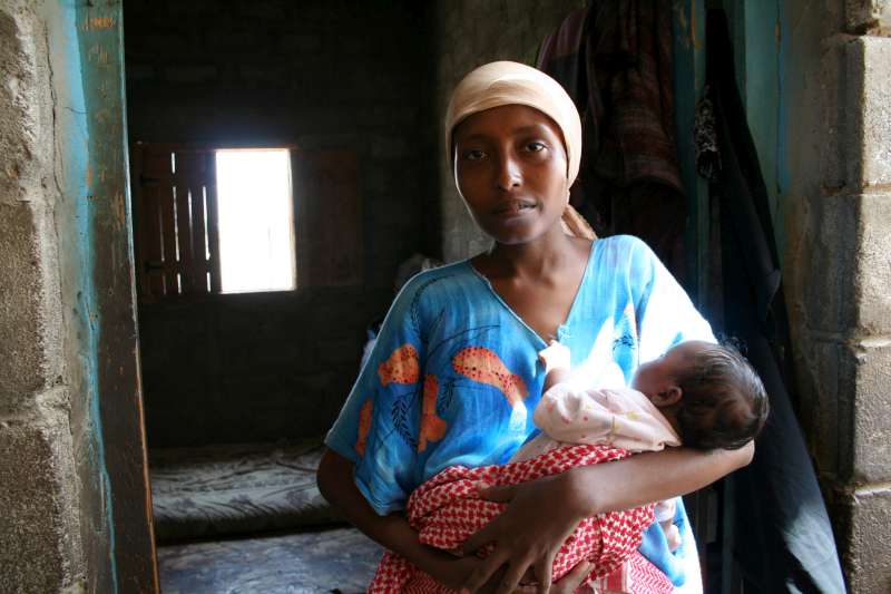 Grateful to have survived the perilous voyage across the Gulf of Aden, a mother embraces her four-month-old infant, who was born in South Yemen's Kharaz refugee camp.