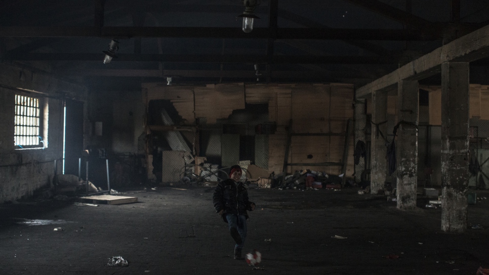 Aziz kicks around a deflated football to keep warm in sub-zero conditions in a Belgrade warehouse where he insists on sleeping despite efforts to persuade him and relatives to move to a government-run shelter. 