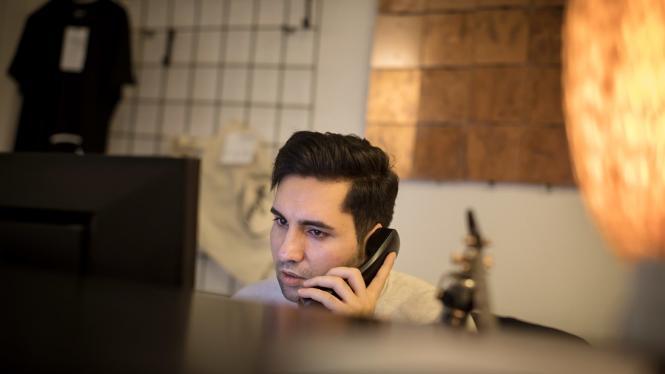 Omid Sharif, from Afghanistan, works at the reception of the hotel. 