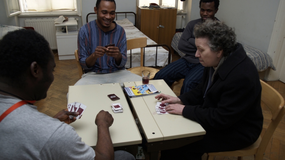Frau Bock plays cards with refugees in Ute Bock House.