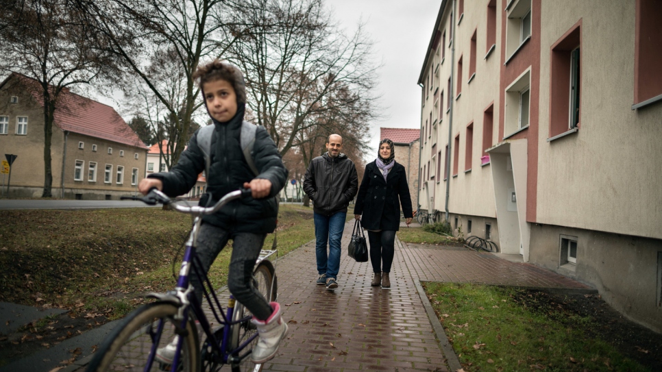 Fadi and Halima walk home with their daughter Kamala.