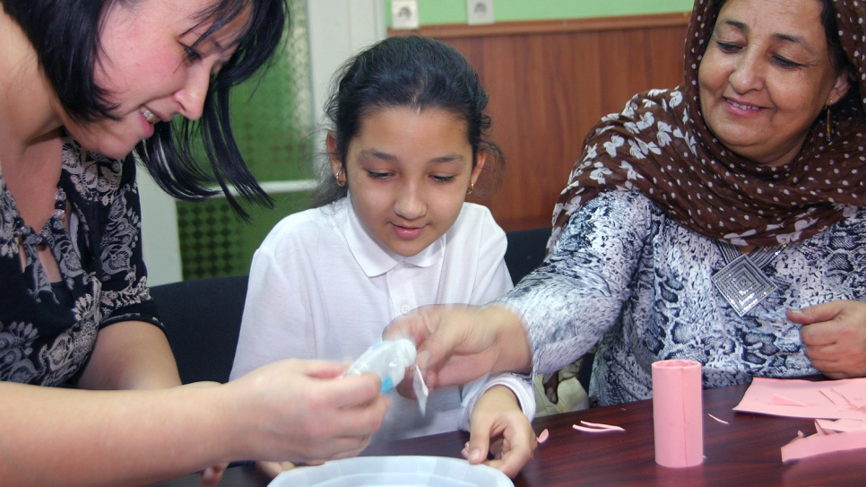 Fahima (right) and her daughter Farnat take part in an arts and crafts activity at a social event for refugees and migrants. They left Afghanistan after a bomb killed two of her siblings.