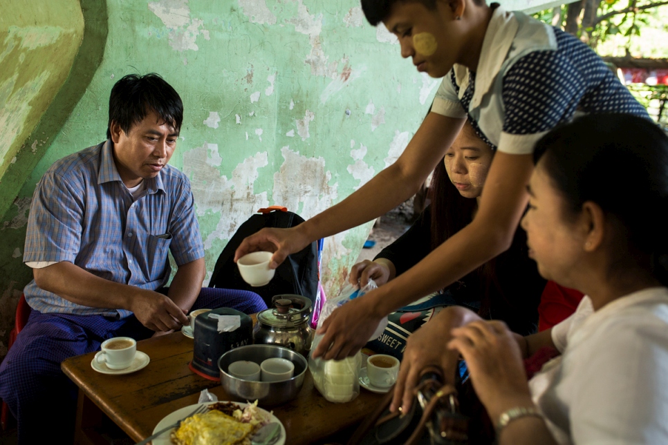 Thant drinks tea with his friends from work in Yangon, Myanmar.