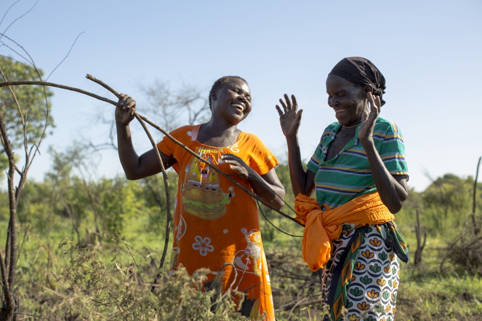 Ugandan grandmother Medina (right) and South Sudanese Betty (left) farm together in Uganda's Yumbe district. Medina gave parts of their land to Betty and her family as they arrived from South Sudan in August 2016. "They can even build their house on my land and stay for as long as they need," says Medina.