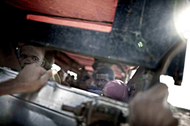 A UNHCR truck makes several stops along the coastal road to pick up new arrivals. 