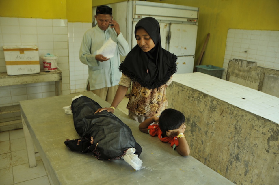 Mimi*, a Rohingya woman from Myanmar, bids farewell to her three-year-old daughter who died days after being rescued by Indonesian fishermen.