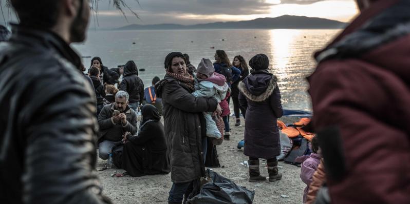 Safe on shore, refugees who made it to the Greek island of Lesbos in February 2016 plan for the next step of their long trek to safety. Photo: Pablo Tosco/Oxfam