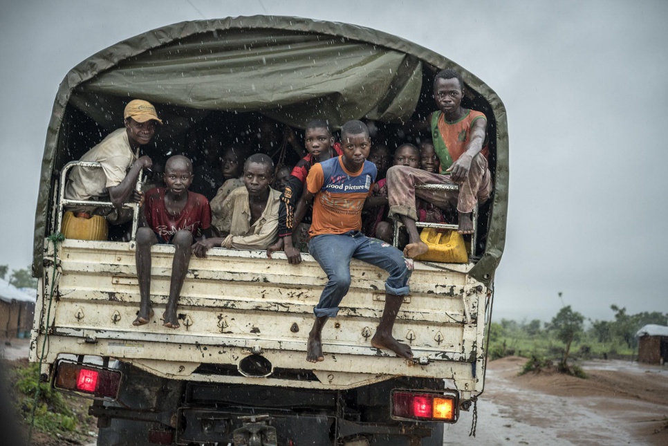 After gathering water nearby, several Congolese return to the Kanteba IDP site in Katanga Province, DRC. The site provides shelter to over 2,000 civilians who fled the Mai Mai Bataka Katanga rebel militia.