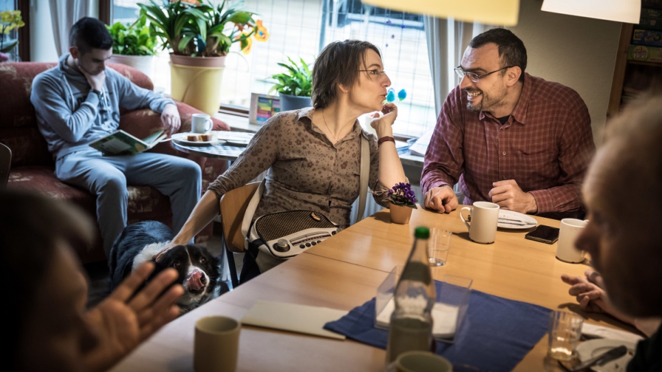 Cornelia, 44, who co-founded the refugee support network 'Welcome To Neu Wulmstorf', chats with Mustafa, 37, from Syria.
