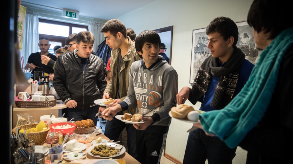 Afghan aslyum-seeker Salim Mohamadi, 22, (middle) chats with new friends at the local community centre.