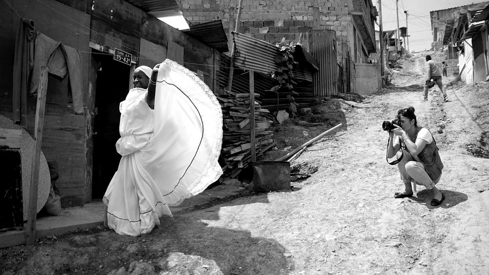 Helena photographs Maribeth dancing outside her house.
