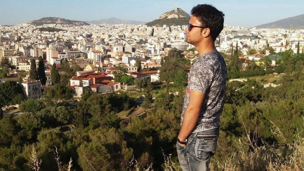 Omid takes in a view of Athens after safely arriving in Greece by boat from Turkey.