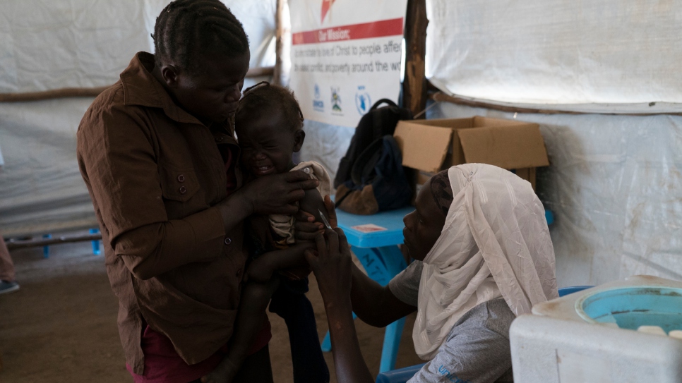 After arriving at Kuluba transit centre, refugee children are given a medical check and vaccinated against disease.