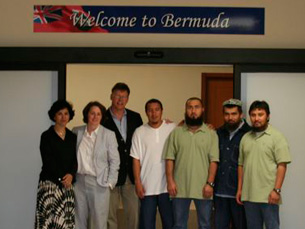 The four Uyghur detainees and their legal team shown on arrival in Bermuda.