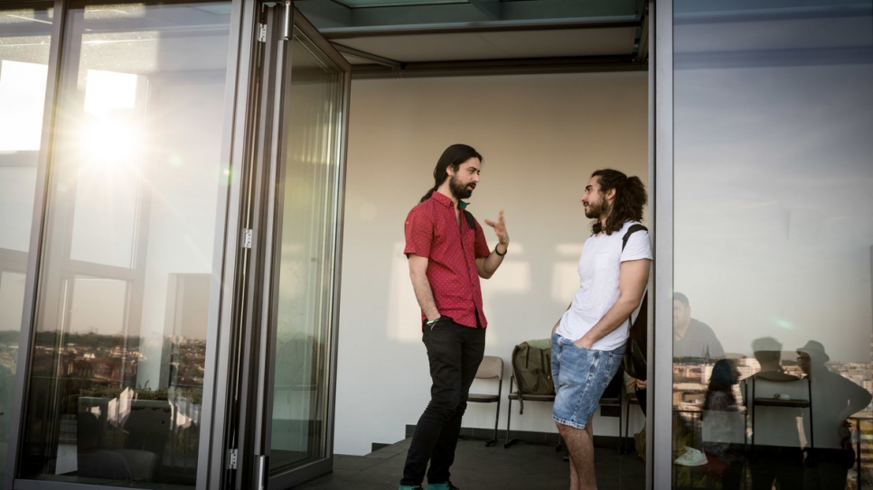 Muhannad chats with a guest at one of the library's book reading events.