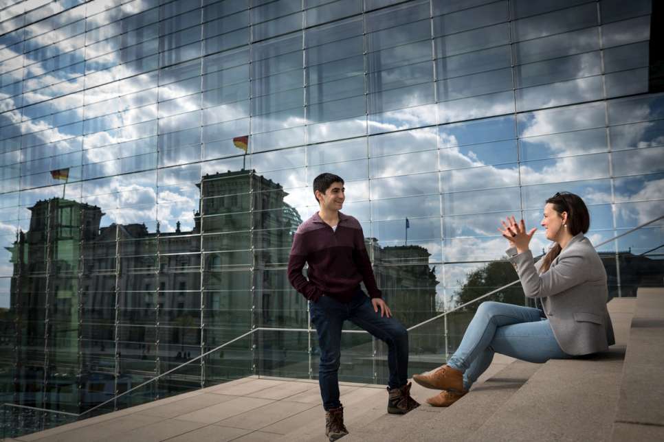 Fahed and Anne-Marie Schumann chat in front of the Reichstag. They quickly became friends after being paired by the German initiative Start With a Friend.