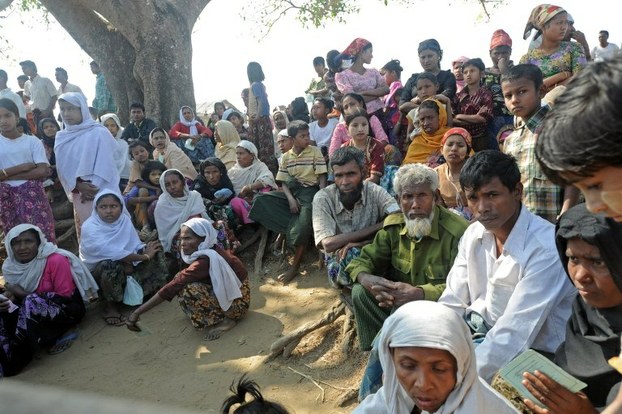 Displaced Rohingyas wait outside a humanitarian center for aid at a camp on the outskirts of Sittwe, Rakhine state, Feb. 26, 2014.