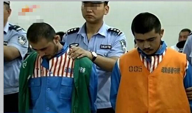 Two recently sentenced human smugglers are shown at their trial in Xinjiang in an undated photo.