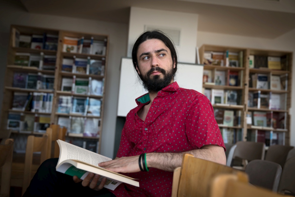 Syrian literature student Muhannad in the library he founded.