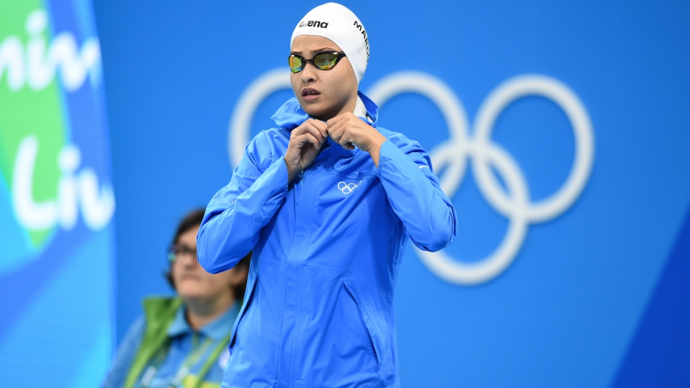 Yusra Mardini, an 18-year-old swimmer who fled the war in Syria, looks anxiously at the Olympic pool as she readies herself for her last race.