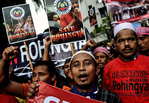 Ethnic Rohingya Muslim refugees shout slogans during a protest against the persecution of Rohingya in Myanmar outside the Myanmar embassy in Kuala Lumpur, Malaysia, Nov. 25, 2016.