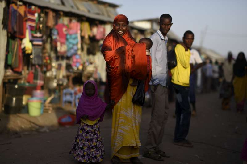 A Somali refugee woman and her children in the streets of Kakuma refugee camp.