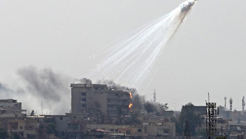 Photo of smoking and burning white phosphorus streaking to the ground in west Mosul on June 2, 2017. 