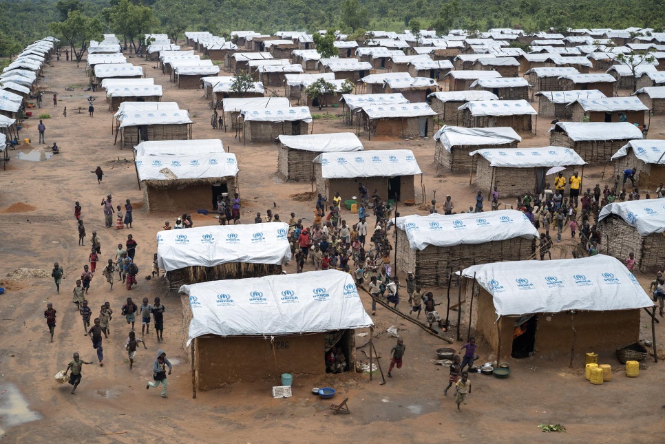 Congolese children run through Kanteba IDP site in Katanga Province. It provides refuge to over 2,000 people who fled violence attributed to the Mai Mai Bataka Katanga rebel militia.