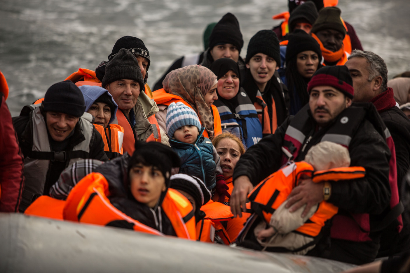 Greece. Boatload of refugees wait to disembark boat.