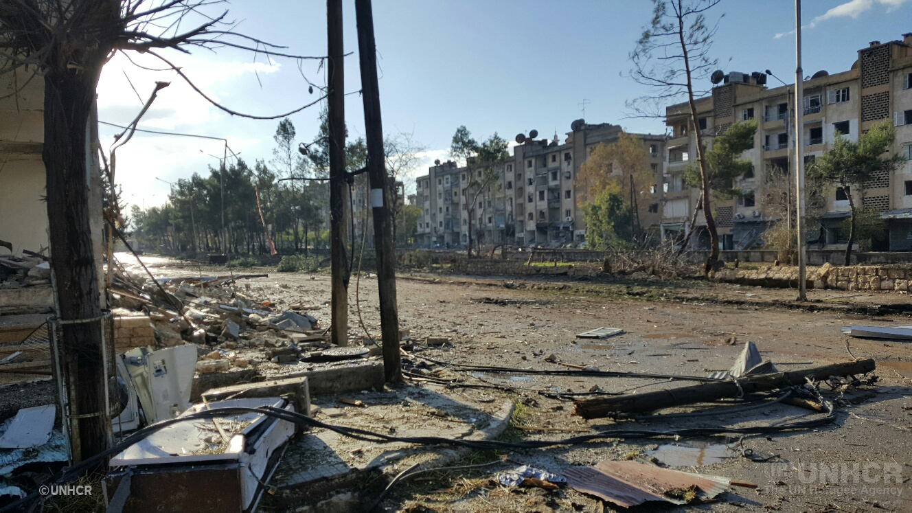 UNHCR winter assistant help prepare rooms in damaged buildings